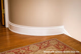 White flexible baseboard molding with optional flexible shoe trim for curved walls and hardwood floors.