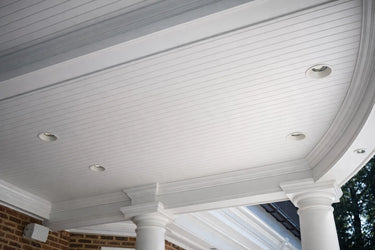 Outdoor covered ceiling using cellular PVC tongue and groove planks with recessed beam accents for a low-maintenance, weather-resistant finish.