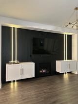 Modern living room with a television mounted on a black paneled wall.