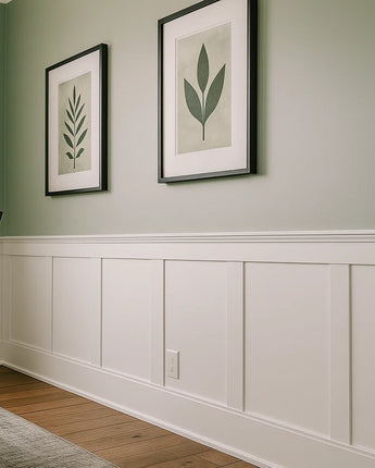 Elite Shaker Paneled Wainscoting Kit installed along a dining room wall, featuring primed shaker stiles, upper and lower rails, and a poplar cap trim in a clean white finish