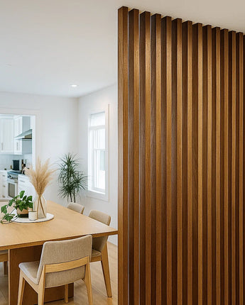 A tall room divider made of evenly spaced walnut wood slats is used to separate open-concept living areas while adding warmth and texture to the space.